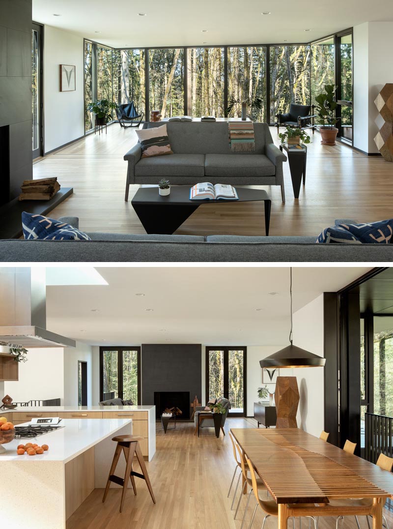 Inside this modern home, the main social areas of the house are open plan, with the living room taking advantage of the view through floor-to-ceiling windows. The interior also features white oak floors that have dark walnut inlay borders. #ModernInterior #LivingRoom #Windows #OpenFloorPlan #OakFloors