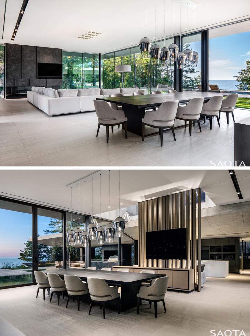 This modern lake house has an open plan living room and dining room that take advantage of the views with floor-to-ceiling glass walls and sliding doors. #LakeHouse #ModernLivingRoom #ModernDiningRoom #OpenPlanInterior #GlassWalls