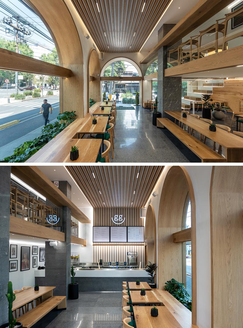 Wood-lined arches with matching windows create alcoves that are deep enough to include plants and a bench seat. #RestaurantSeating #RestaurantWindows #WoodArches #ArchedWindows #RestaurantDesign