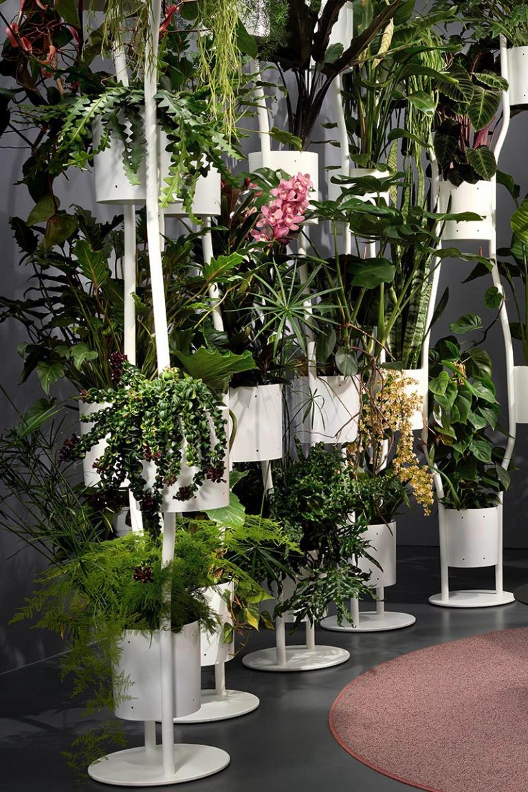 A Room Divider That Incorporates Plants Into Its Design
