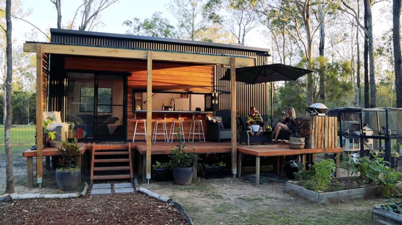 This modern tiny house black corrugated metal siding, wood accents, and two loft bedrooms. #TinyHouse #2BedroomTinyHouse #ModernTinyHouse #Architecture