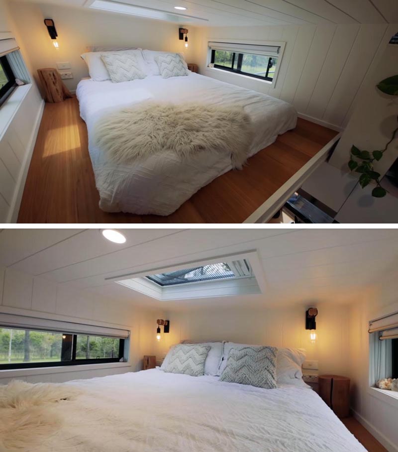 This modern tiny house has a loft bedroom, with windows on each side, and a skylight in the ceiling above. #TinyHouse #TinyHouseBedroom #TinyHouseSkylight #LoftedBedroom