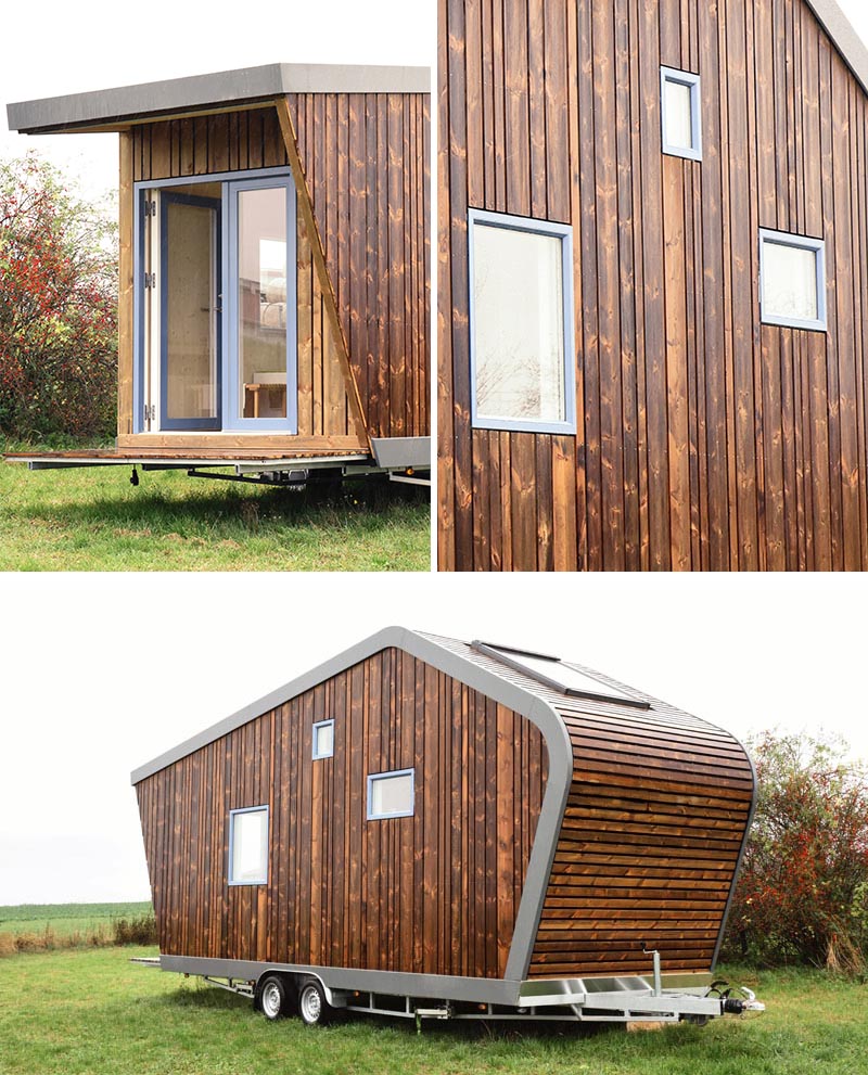 This modern tiny house is clad in wood and inside there's a dining area, kitchen, bathroom, desk, living area, and a lofted bedroom. #TinyHouse #ModernTinyHouse #TinyHome #SmallLiving #WoodSiding