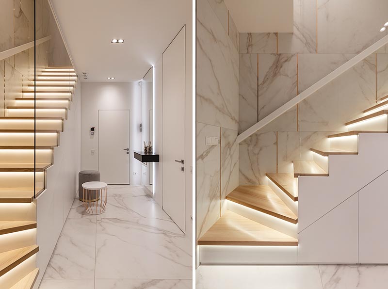 These modern wood stairs have a tread with an overhang (or nosing) that extends past the riser, allowing room for a thin strip of lighting to be attached to the underneath surface. #Stairs #StairsWithLighting #StairDesign #HiddenLighting