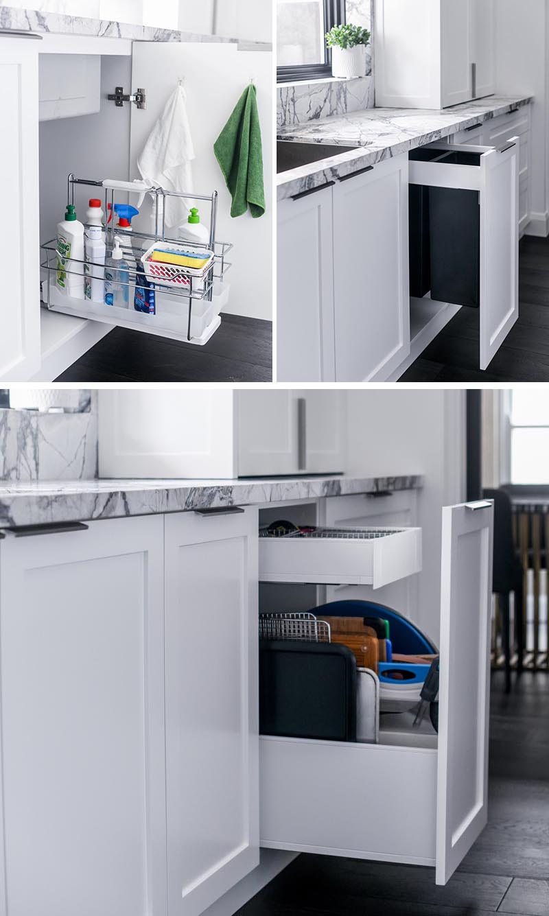 Underneath this kitchen sink, there's a cabinet with a pull-out caddy that holds a variety of cleaning products. In the adjacent cabinets, there's pull-out garbage and recycling bins, and a vertical drawer for storing baking trays and cutting boards. #KitchenDesign #KitchenIdeas #KitchenStorage #KitchenOrganization