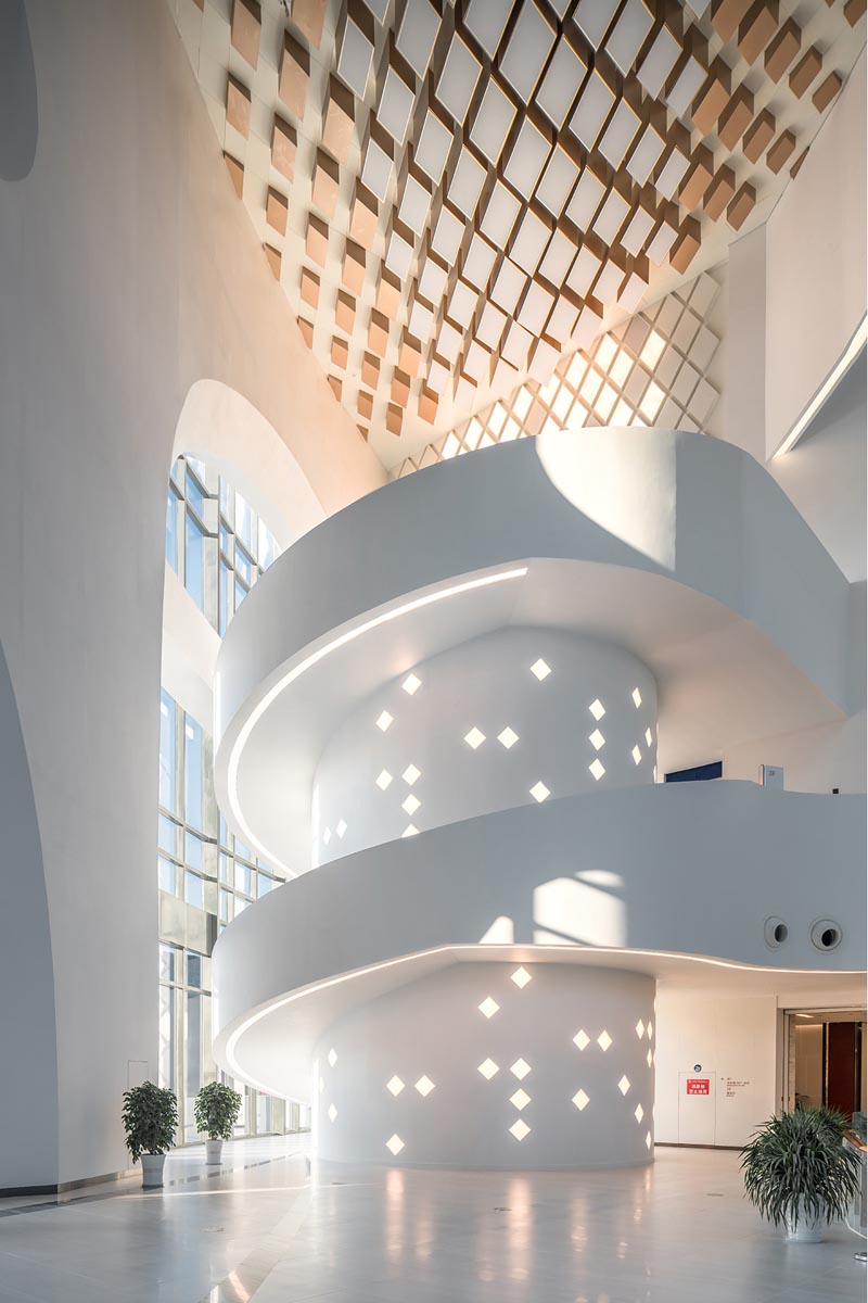 An oversized white spiral staircase with embedded lighting.