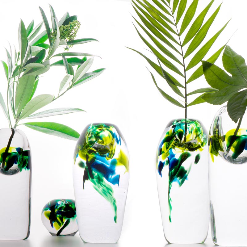 A glass vase with delicate colors inspired by rainforests.