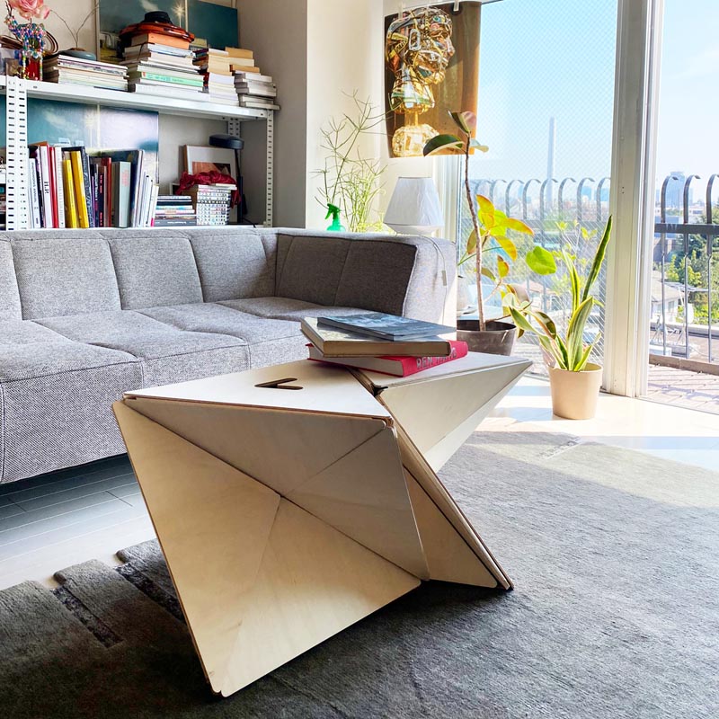 A modern folding stool that doubles as a table.