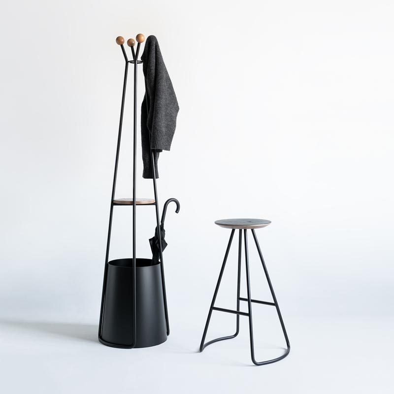 A modern umbrella stand with coat rack, and a matching stool.