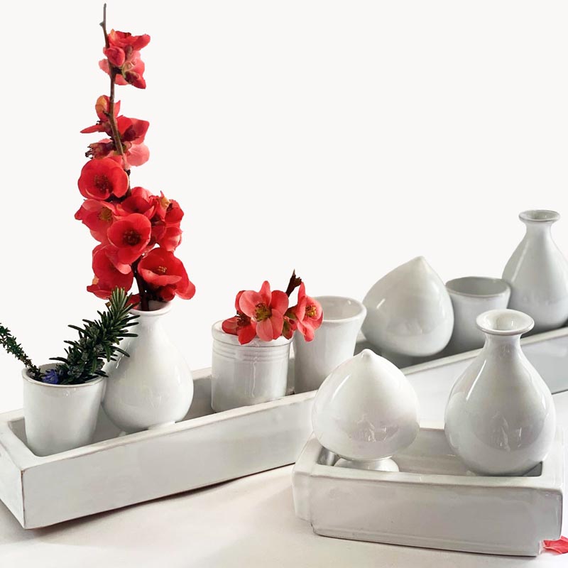 A collection of small white modern vases.