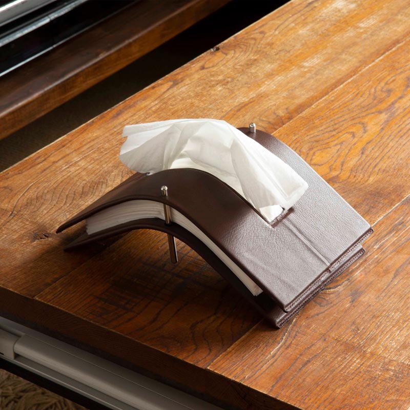 A modern tissue holder made from steel and leather.