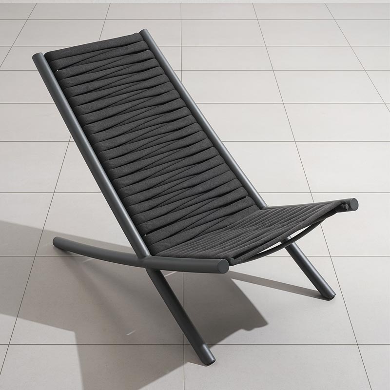 A modern black chair with woven seat.