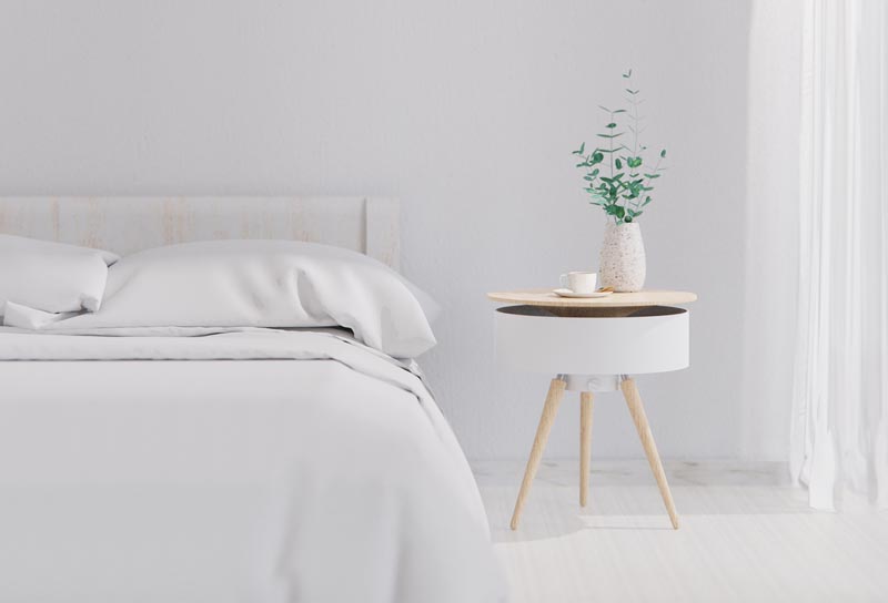 A modern white and wood bedside table.