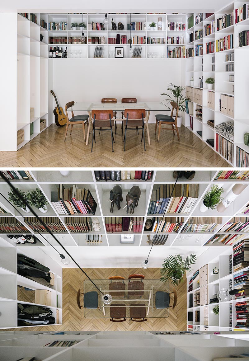 This modern white double-height bookshelf covers both the ground and first floor of this house. Starting in the open plan living room and dining room, the bookshelf wraps around the walls before traveling vertically towards the first floor of the house. #Bookshelf #DoubleHeightBookshelf #ShelvingIdeas #BuiltInBookshelf