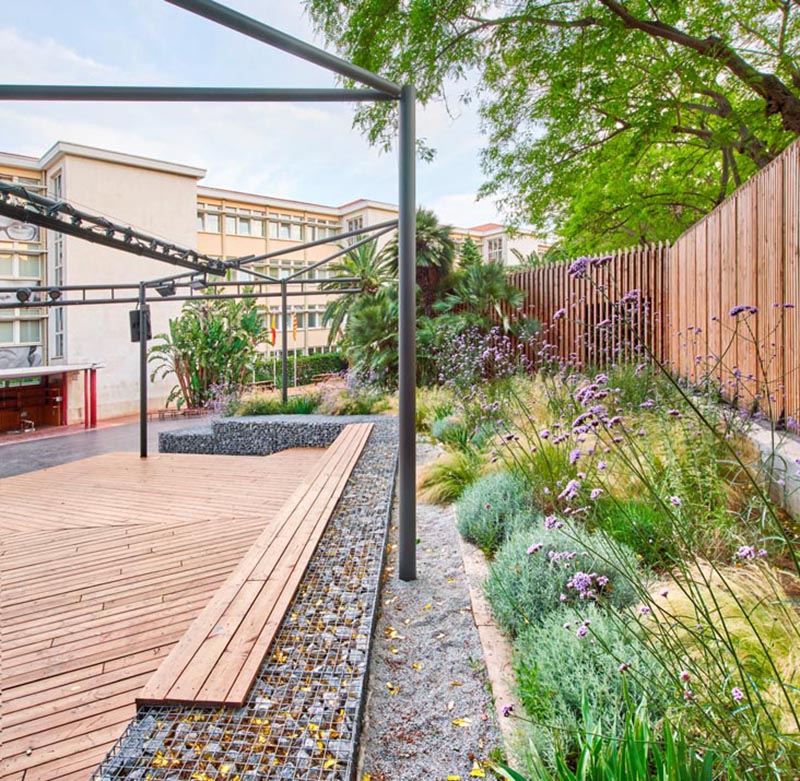 The zig-zag gabion walls form the basis of the bench seating and provide retaining walls for the surrounding gardens and the stage. #Gabions #GabionBench #GabionRetainingWall #Landscaping #LandscapeDesign