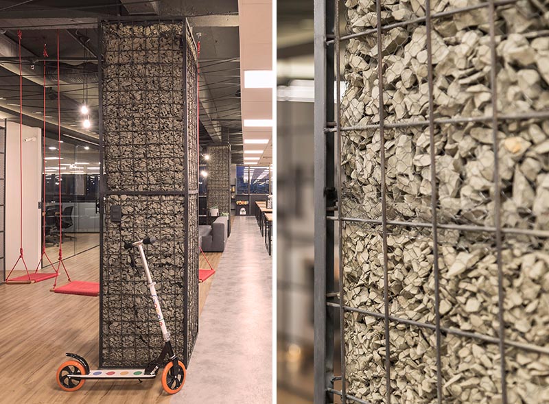 Columns, whether they're in the workplace or at home, are often left as raw concrete or simply painted, however in this office the columns have been turned into feature accents named gabions. #Gabion #WorkplaceDesign #Columns