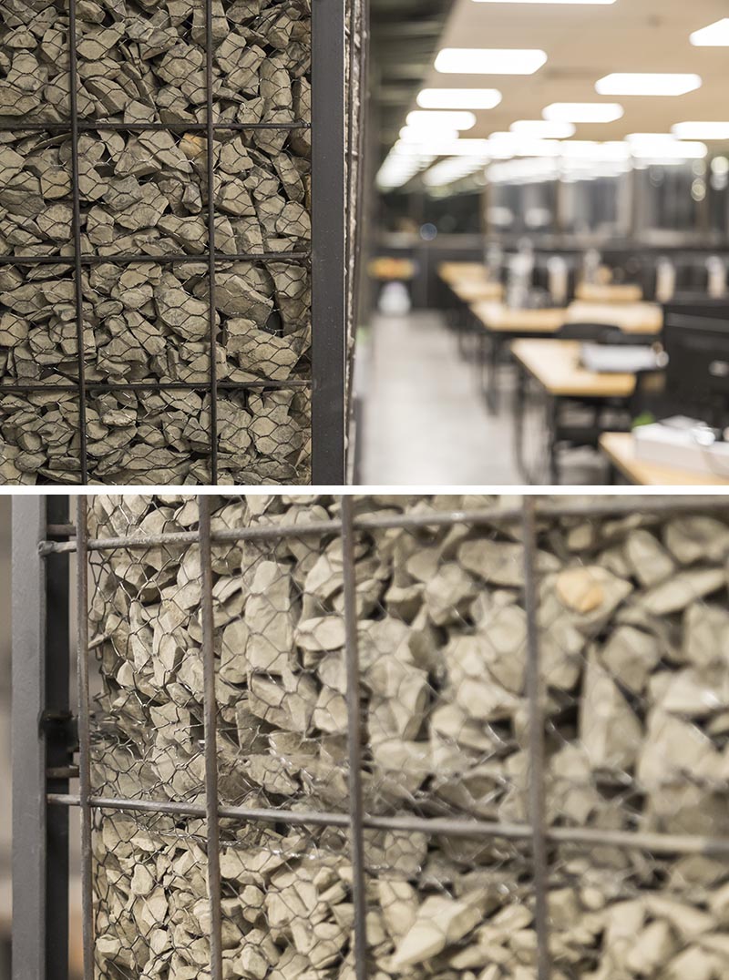 Columns, whether they're in the workplace or at home, are often left as raw concrete or simply painted, however in this office the columns have been turned into feature accents named gabions. #Gabion #WorkplaceDesign #Columns