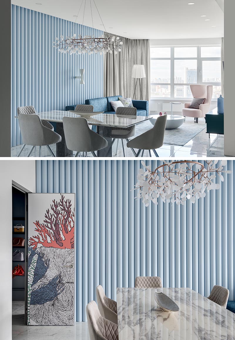 Designed as a way of adding texture to the room, this soft blue accent wall is made from panels that have ribbed finish, allowing the natural light to create ever-changing shadows on the wall. #SoftBlueInterior #BlueAccentWall #TexturedAccentWall #InteriorDesign #Blue #LivingRoom