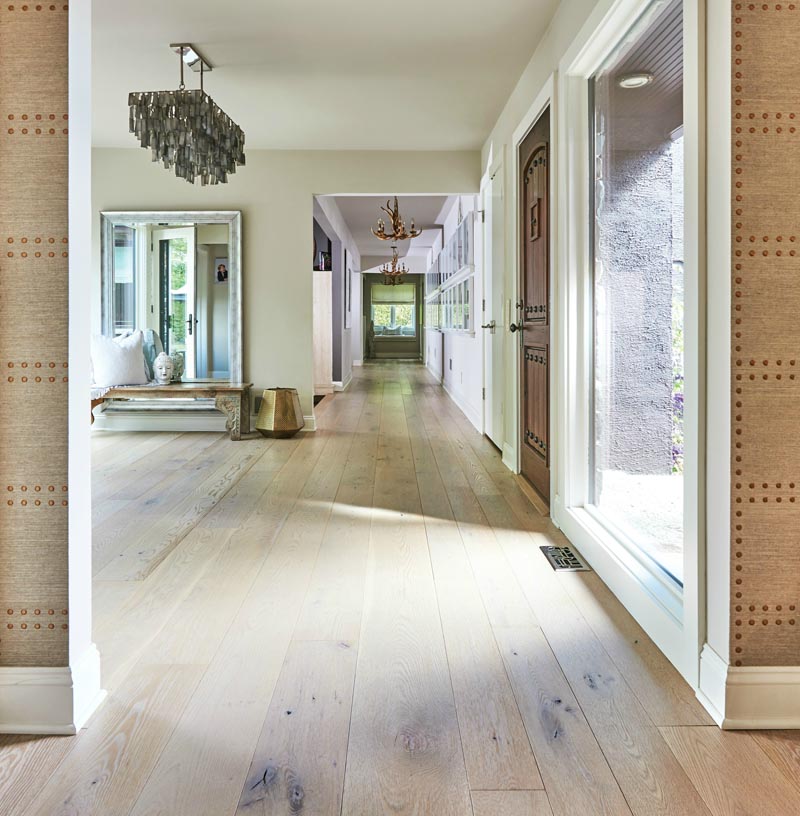 Light-toned wide plank wood flooring is often chosen for contemporary homes, as it adds visual interest to an interior without drawing attention away from other design elements. #WidePlankFlooring #LightWoodFlooring #FlooringIdeas