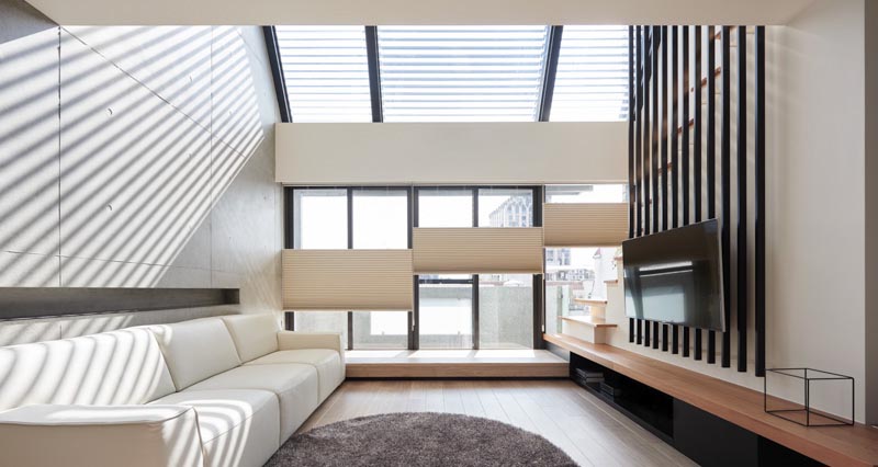 The black poles in this modern living room provide a place to mount the television. #TVMount #ModernInterior #InteriorDesign