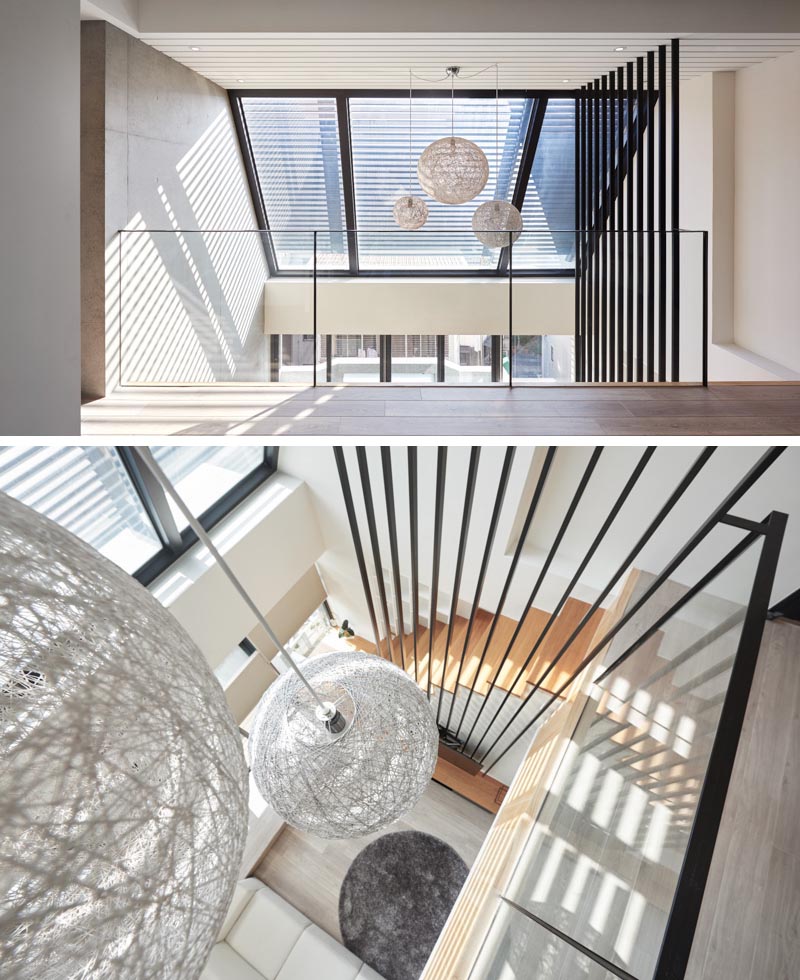 Interior design firm INDOT has designed a modern apartment in Taiwan, that features a bold collection of 12 black poles that travel from the living room up to the high ceiling. #HighCeiling #TVMount #StairDesign