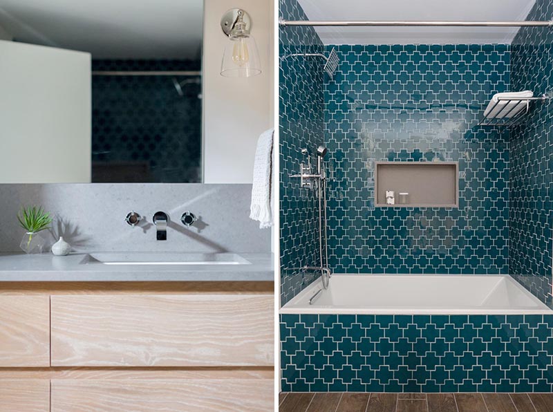 In this modern bathroom, a quartz countertop sits atop a custom wood vanity, while dark teal Swiss cross tile was used to add a punch of pattern and color, and a shower niche provides a shelving element. #ModernBathroom #CrossTile #TealTile