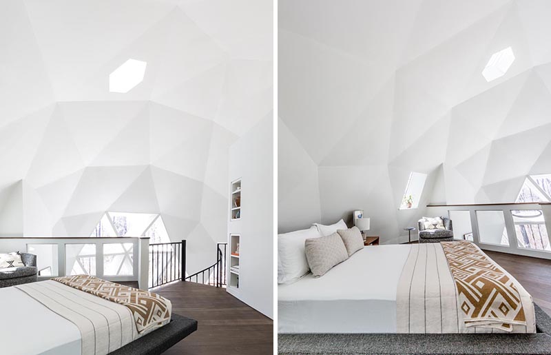 The lofted master bedroom of this geodesic dome house has been kept minimal in its design allowing the architecture of the building to be showcased. A low profile platform bed is has teak nightstands on either side, and a swivel chair creates a reading area by the window. #MasterBedroom #GeodesicDome #LoftBedroom