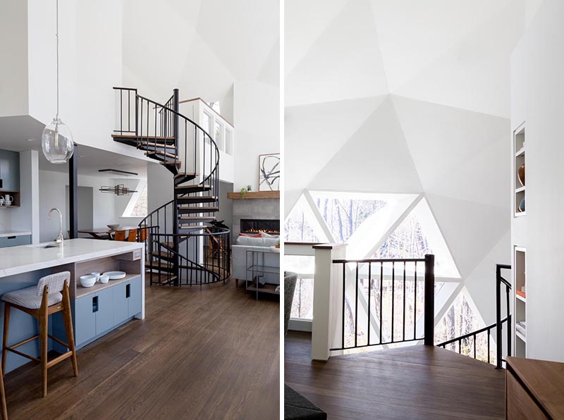 This renovated geodesic dome house features a black steel spiral staircase with wood treads that leads up to the loft where the master bedroom is located. #SpiralStairs #GeodesicDome
