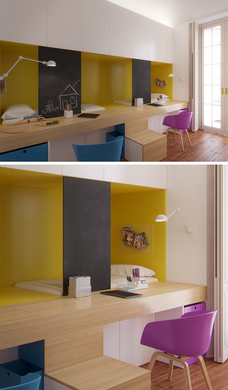 This modern shared kid's bedroom has two beds that are nestled behind the built-in desks, with the desktop forming part of the stairs to reach the beds. The sleeping niche is highlighted with yellow, while above, white cabinets provide storage, and safety screens double as a chalk board for the children to draw on. #KidsBedroom #SharedBedroom #BedroomIdeas #BuiltInBeds #BuiltInDesks