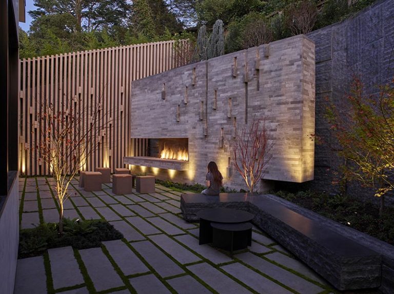 Image showcasing This Outdoor Fireplace Is Also A Climbing Wall