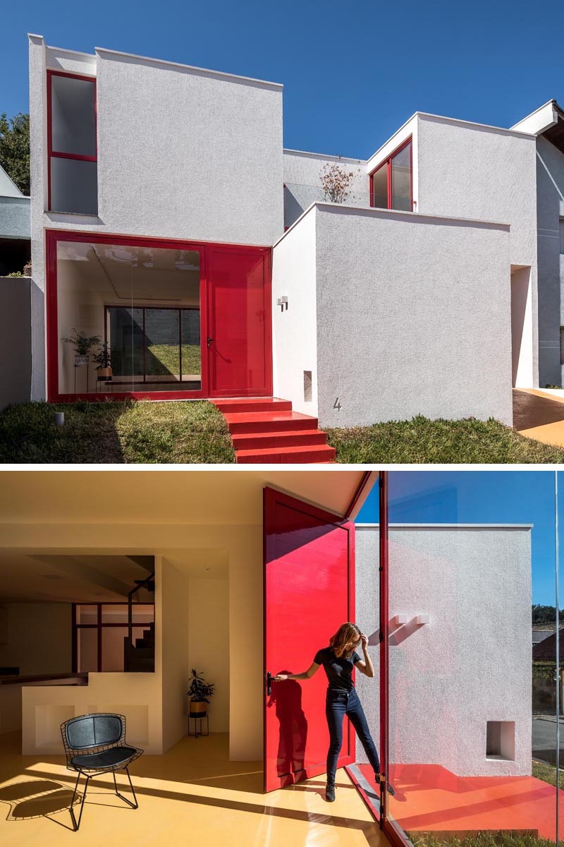 The red front door and window frame provide a pop of color to this modern white house, and match the steps that lead connect to the sidewalk. #RedFrontDoor #RedFrontSteps #RedWindowFrames