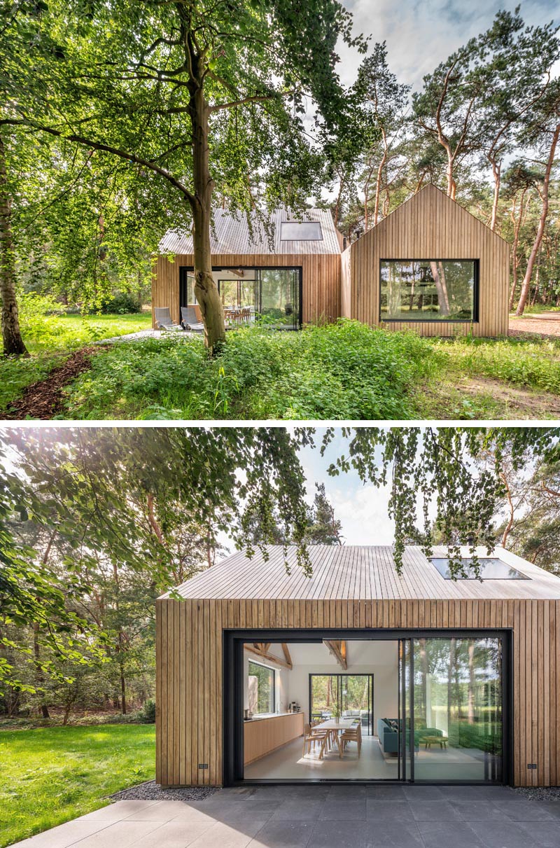 Large siding black-framed sliding glass doors connect the outdoor terraces with the interior spaces of this modern wood clad house. #ModernHouse #WoodHouse #SlidingDoors #BlackFrames