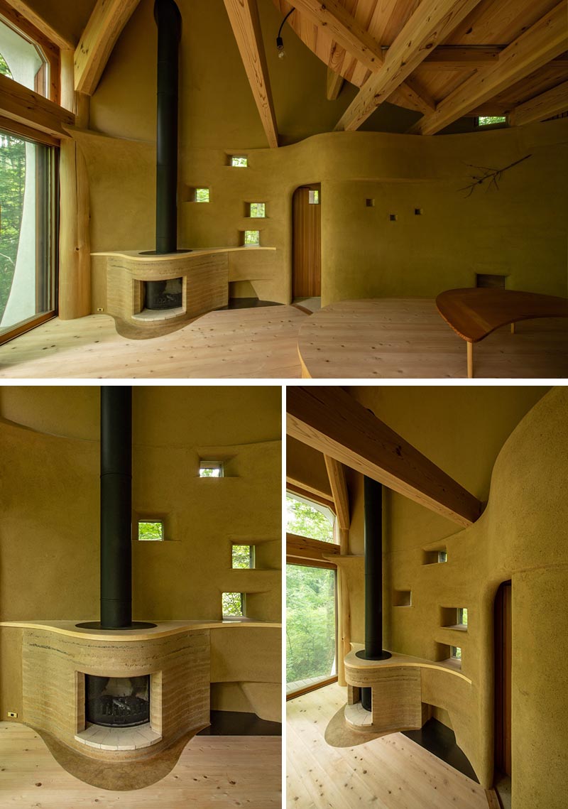 This small house has a fireplace that curves out from the wall, with its surround made from rammed earth. #Fireplace #RammedEarth #InteriorDesign