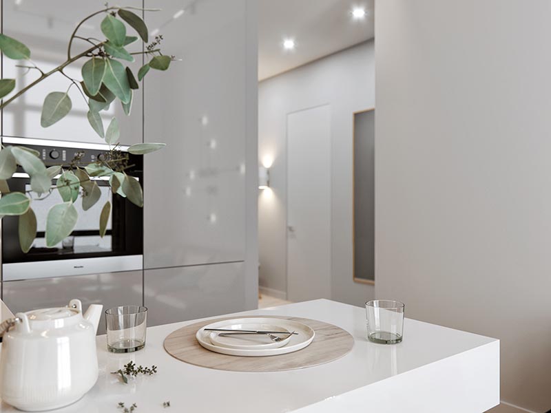 A small kitchen with an L-shaped countertop, integrated fridge, minimalist grey cabinets, hidden lighting, and a cantilevered peninsula for dining. #SmallKitchen #TinyKitchen #KitchenDesign #KitchenLayout #IntegratedFridge