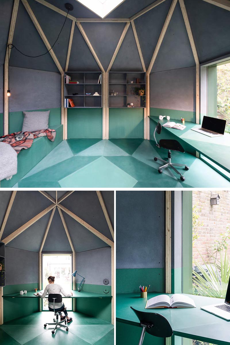 A modern backyard office with a geometric shape, a desk by the window, and a built-in bench with a fold out bed.