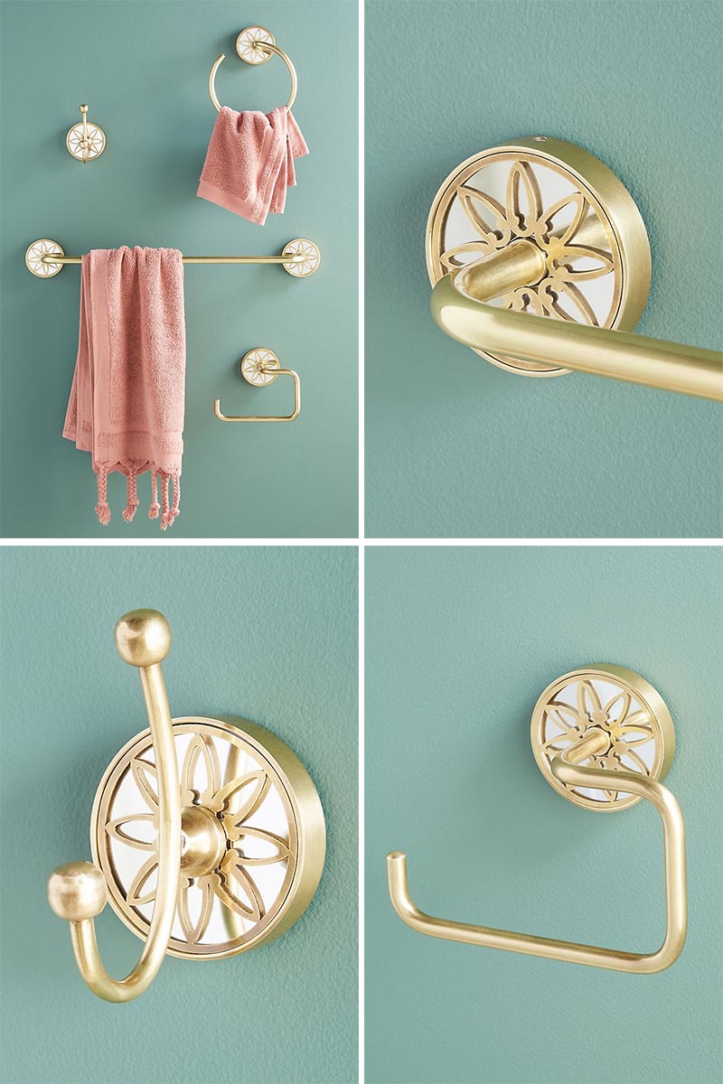 Metallic brass bathroom hardware with a delicate decorative motif.