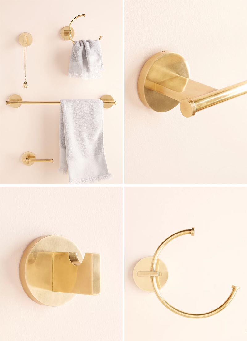 Modern metallic bathroom hardware with a brass finish.