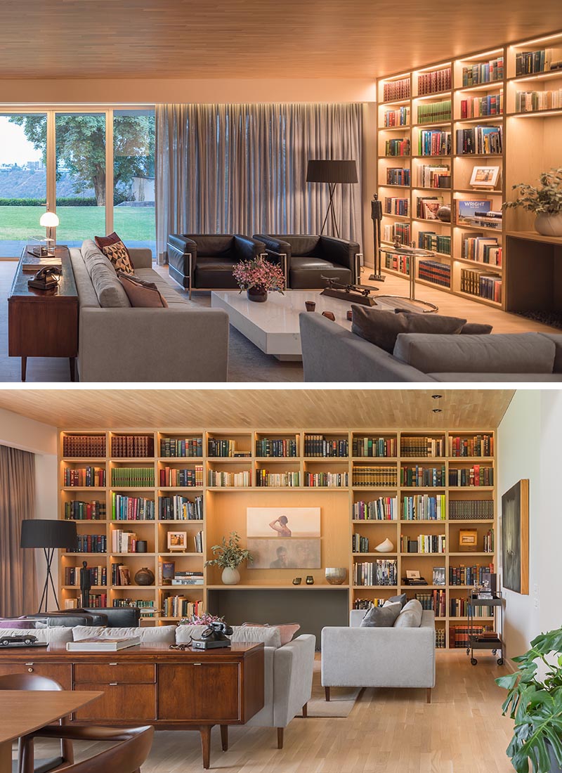 A living room wall full of shelving with hidden lighting.