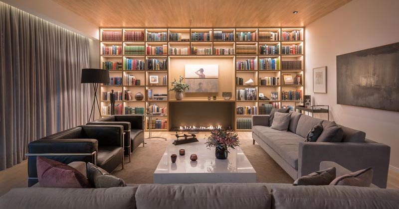 A Full Wall Of Shelving With Hidden Lighting Is A Bright Idea For This Living Room