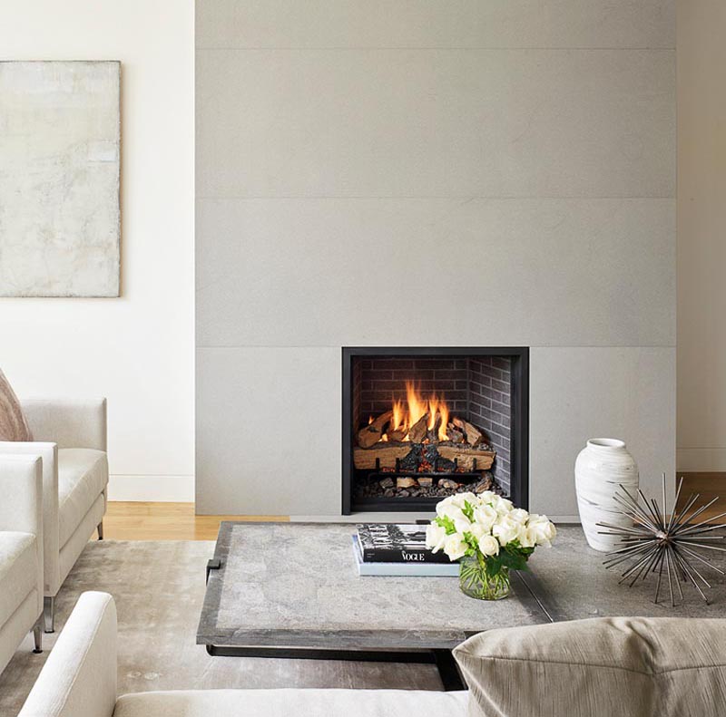 A smooth grey fireplace surround complements the interior, which has a neutral color palette.