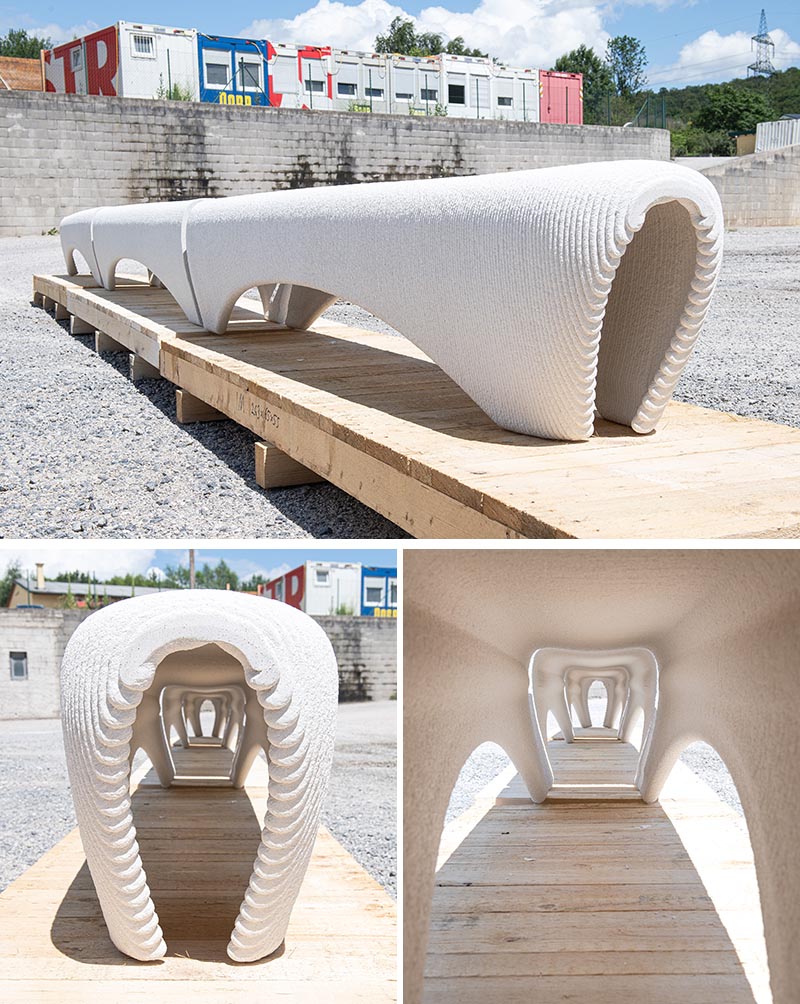 A 3D printed white concrete outdoor bench.