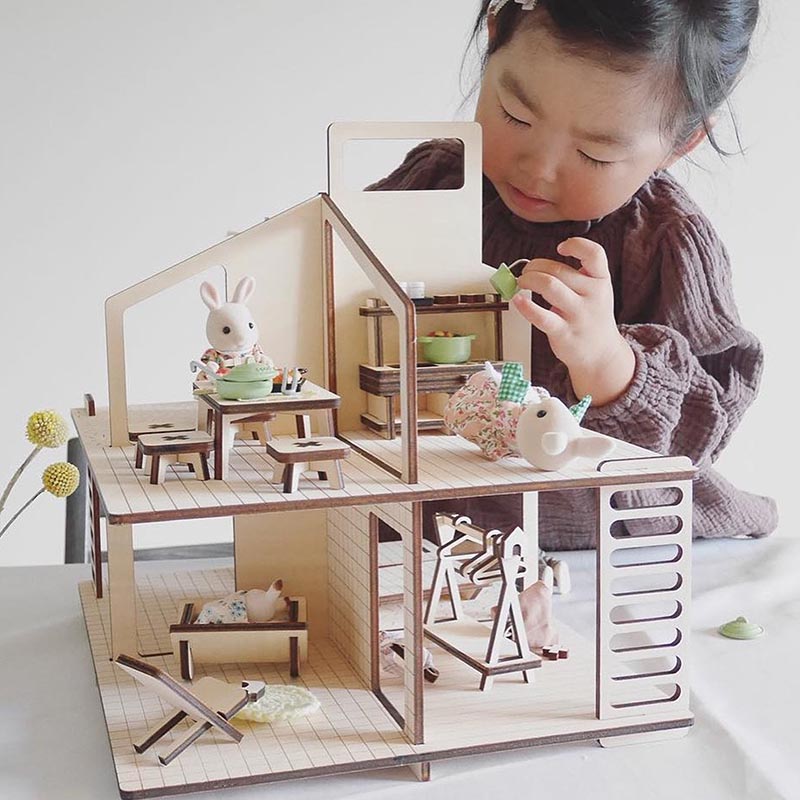 Modern wood dollhouse with matching furniture.