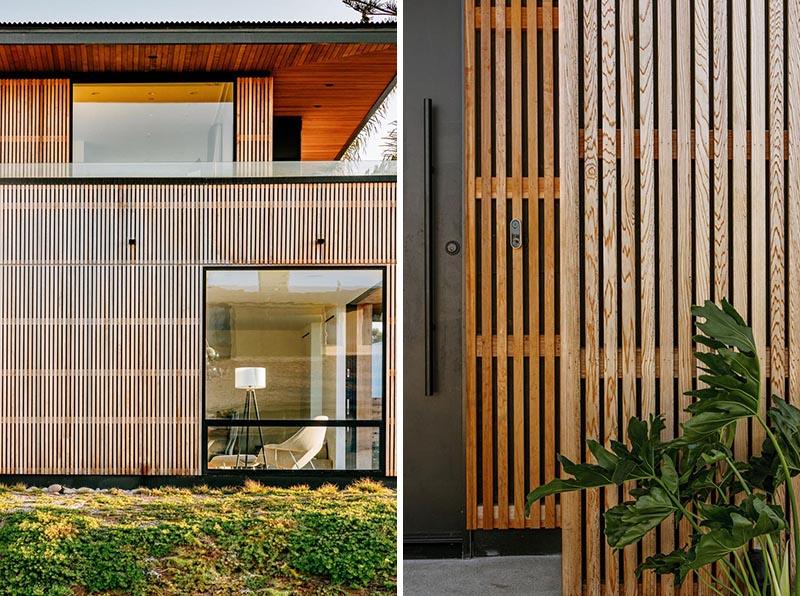 A modern house with cedar siding and overhanging roof eaves.