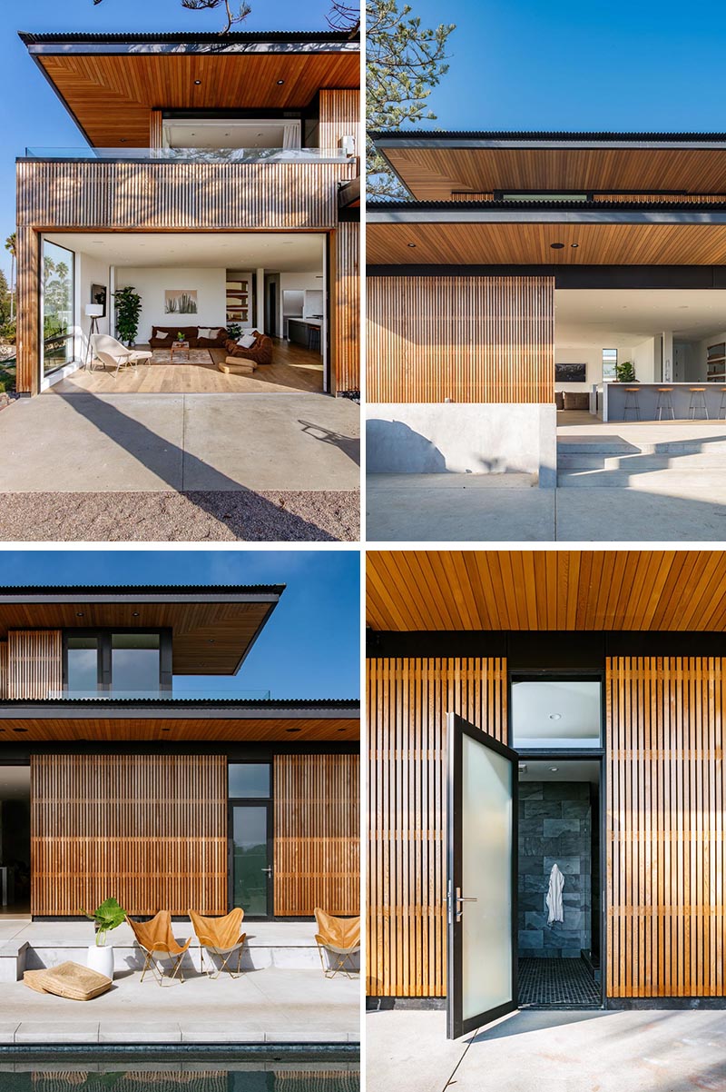 A house with wood slat siding opens up to to outdoor spaces and is accented by black details like the window frames.