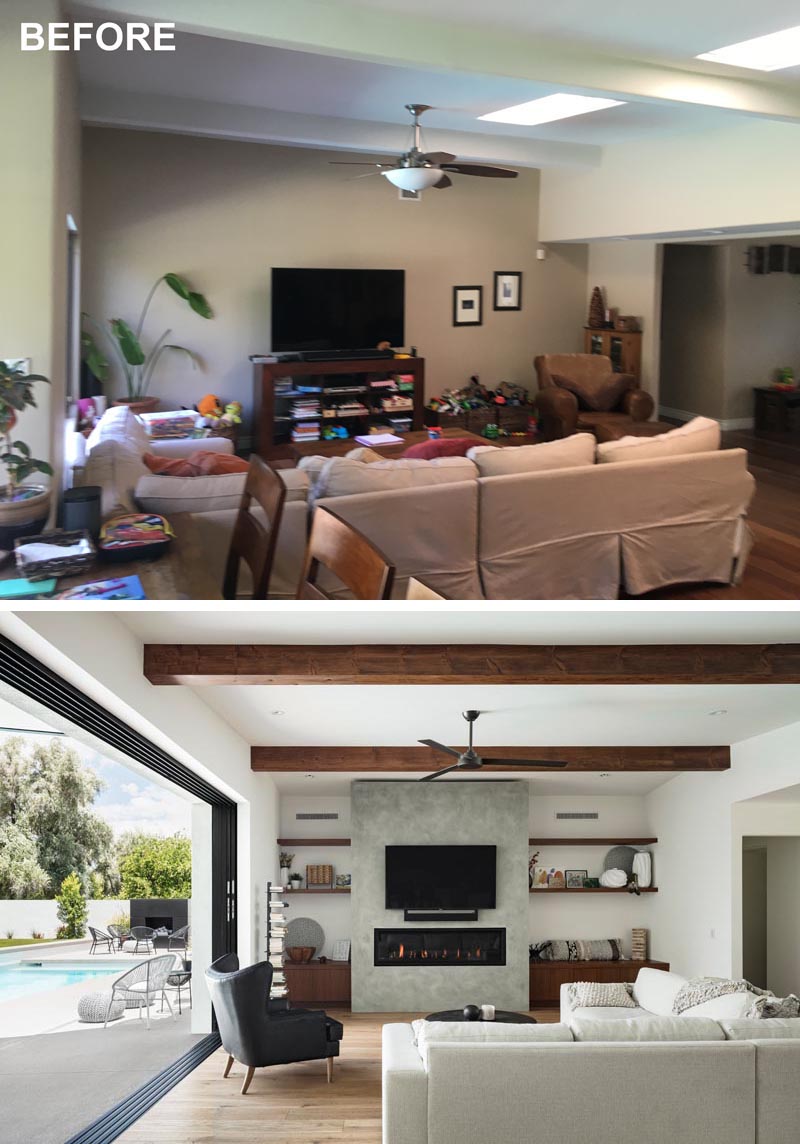 A renovated living room with a plastered fireplace and walnut-wrapped beams.