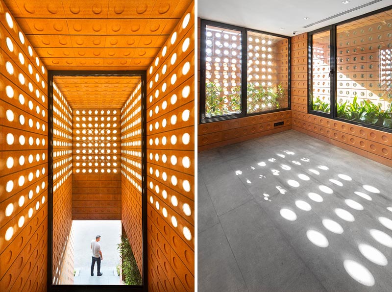 Custom modern bricks with small round windows shine light though to the interior of the building.