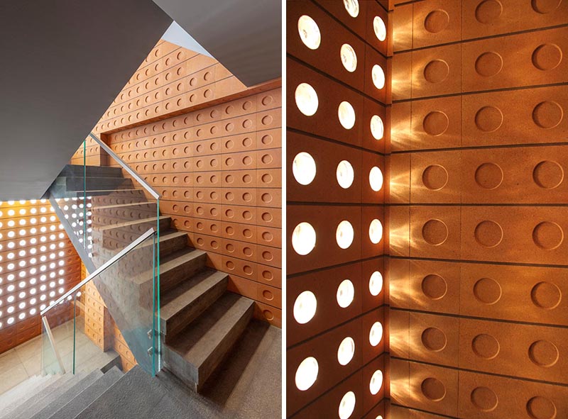 Custom modern bricks with small windows and round indents were used in the construction of an office building.