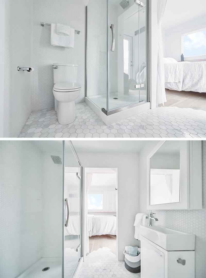 A small white bathroom with hexagonal floor tiles.
