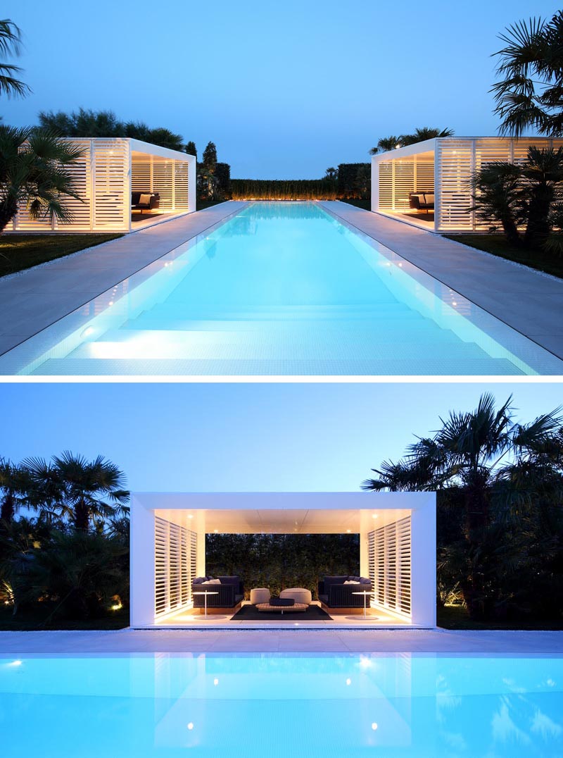 A pair of modern cabanas flank a long infinity edge swimming pool.