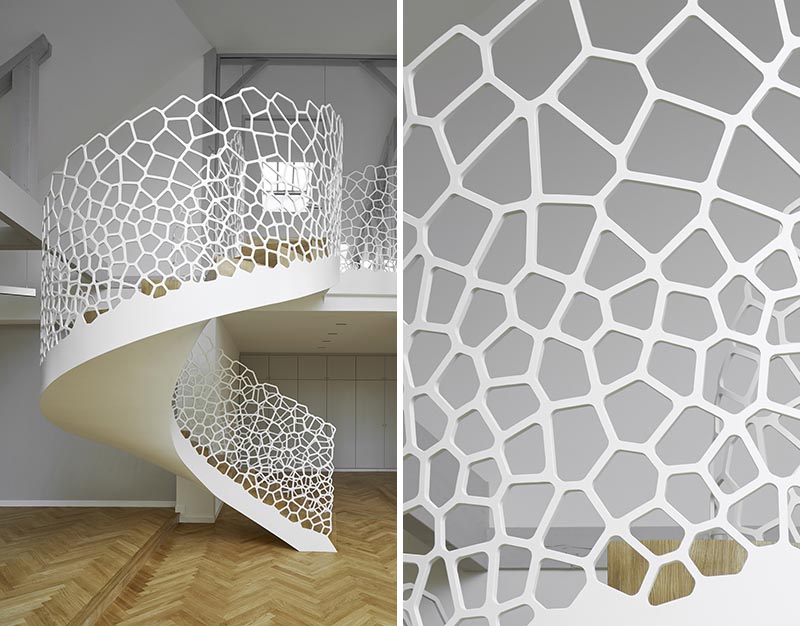 This Parisian apartment features an artistic white spiral staircase with organic cell-like shapes for the balustrade. #SpiralStaircase #WhiteSpiralStairs #WhiteStaircase #SculpturalStairs #ArtisticStairs